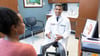 Radiologist Rakesh Navuluri, MD, discussing uterine fibroid embolization (UFE) with a fibroids patient